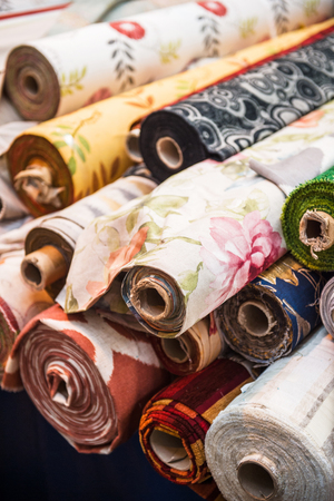 Rolls of tissues at traditional textile covered market with multiple different colors and texturesのeditorial素材
