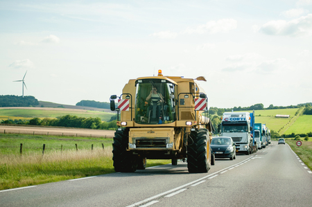FRANCE, JUL 11, 2011: Large agricultural Machine - Special Transport driving on French road with traffic jam behindのeditorial素材
