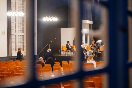 STRASBOURG, FRANCE - MAR 18, 2016: View through the window of a building at the classical music orchestra team preparing for the concert in Strasbourg, Franceのeditorial素材