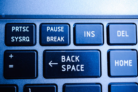 Backspace button on the keyboard closeup surrounded with Print Screen, Pause Breack, Insert , Home...