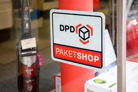 BADEN-BADEN, GERMANY - NOV 20, 2014: DPD Paket Shop logo on the entrance of a shop offering pick-up service for online orders. DPD is an international parcel delivery company owned by GeoPost La Poste Franceのeditorial素材