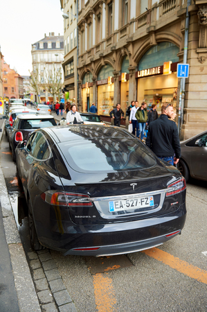 STRASBOURG, FRANCE - MAY 14, 2016: Beautiful Tesla Model S car parked in the center of the city - focus is on the carのeditorial素材