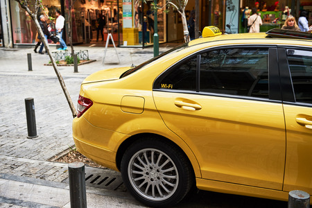 ATHENS, GREECE - MAR 29, 2016: Yellow Taxi cab with Wi-Fi sticker offering free internet service to travelersのeditorial素材