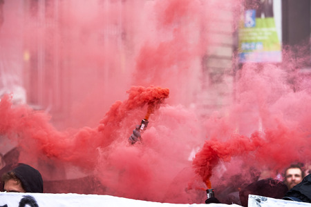 STRASBOURG, FRANCE - MAY 19, 2016: GRoup with covered faces and smoke grenades throwing paint towards Banque de France building during a demonstrations against proposed French government's labor and employment law reformのeditorial素材
