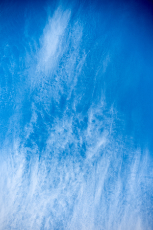 Beautiful blue sky with scattered clouds on a summer dayの写真素材