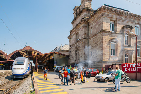 STRASBOURG, FRANCE - JUN 6, 2016: Protesters making barbeque outside the Gare de Strasbourg, during a demonstration by railway workers of French state rail operator SNCF, as part of a strike to defend their work conditions.のeditorial素材