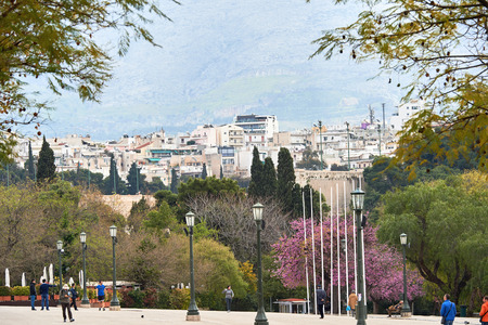 Athens, Greece - March 27, 2016: The National Garden or the Royal Garden, the majestic public park of 15.5 hectares in the center of the Greek capital, Athens behind the Greek Parliament building with touristss and locals having fun on a sunny spring dayのeditorial素材