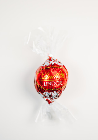 KILCHBERG, SWITZERLAND - MARCH 20, 2014: Lindt Lindor chocolate truffle on a white background. Lindt is one one of the lastgest luxury chocolate and confectionery company worldwide with more than 30 factories worldwideのeditorial素材