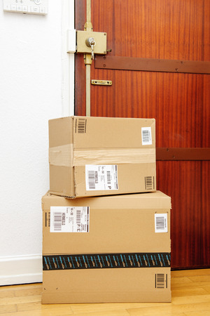 PARIS, FRANCE - SEP 4, 2016: Amazon boxes left at the door with logotype printed on cardboard box.  Amazon is an American electronic e-commerce company distribution worlwide e-commerce goodsのeditorial素材