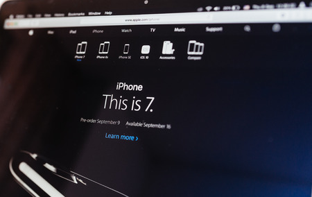PARIS, FRANCE - SEP 8, 2016: Tilt-shift lens over Apple Computers website on MacBook Pro Retina in a geek creative room environment showcasing official name this is iPhone 7のeditorial素材