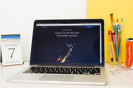 PARIS, FRANCE - SEP 8, 2016: Apple Computers website on MacBook Pro Retina in a geek creative room environment showcasing the new LTE Antennaのeditorial素材