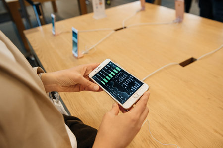 PARIS, FRANCE - SEPTEMBER 16, 2016: New Apple iPhone 7 Plus being tested by woman after purchase - ....