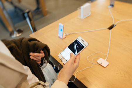 PARIS, FRANCE - SEPTEMBER 16, 2016: New Apple iPhone 7 Plus being tested by woman after purchase - testing new Touch Id button. New Apple iPhone tends to become one of the most popular smart phones in the world in 2016のeditorial素材