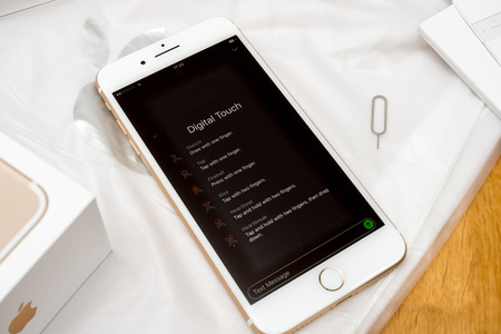 PARIS, FRANCE - SEP 16 2016: New Apple iPhone 7 Plus unboxing in the first day of sales - new message - digital touch . New Apple iPhone acclaims to become the most popular smart phone in the world in 2016のeditorial素材