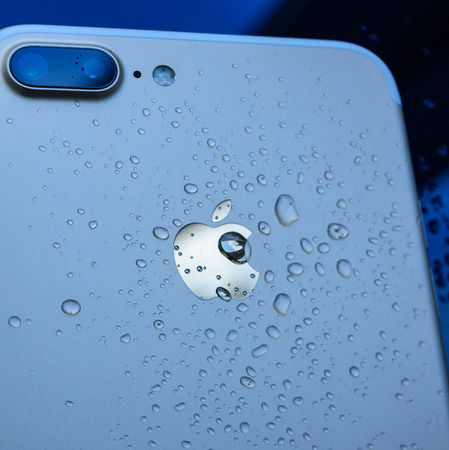 PARIS, FRANCE - SEP 26, 2016: New Apple iPhone 7 Plus unboxing and testing - drops on apple logo on rear of the phone. New iPhone7 is one of the best waterproof smart phone in the worldのeditorial素材