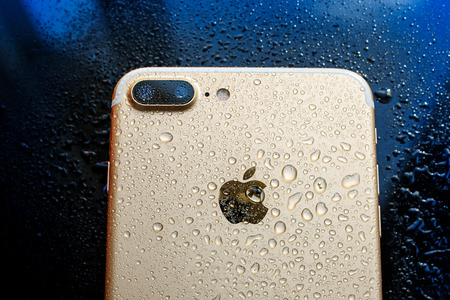 PARIS, FRANCE - SEP 26, 2016: New Apple iPhone 7 Plus unboxing and testing - rear view of water splashed phone. New iPhone7 is one of the best waterproof smart phone in the worldのeditorial素材
