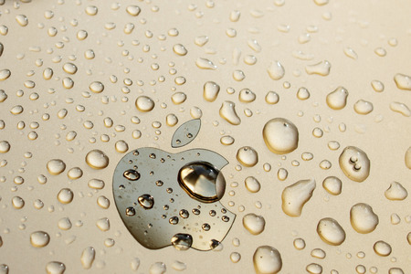 PARIS, FRANCE - SEP 26, 2016: New Apple iPhone 7 Plus unboxing and testing - Apple logo covered with water drops. New iPhone7 is one of the best waterproof smart phone in the worldのeditorial素材