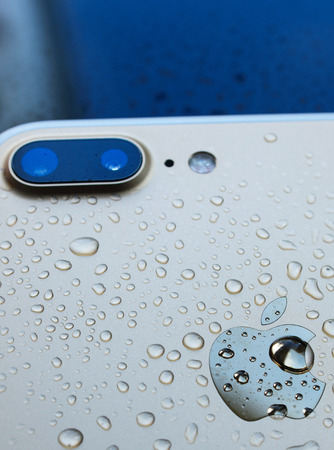 PARIS, FRANCE - SEP 26, 2016: New Apple iPhone 7 Plus unboxing and testing - vertical shot of rear of iphone after immersing in water. New iPhone7 is one of the best waterproof smart phone in the worldのeditorial素材