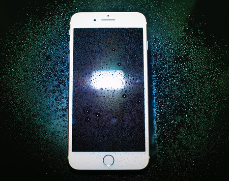 PARIS, FRANCE - SEP 26, 2016: New Apple iPhone 7 Plus unboxing and testing - abstract view of iPhone 7 plus covered with drops . New iPhone7 is one of the best waterproof smart phone in the worldのeditorial素材