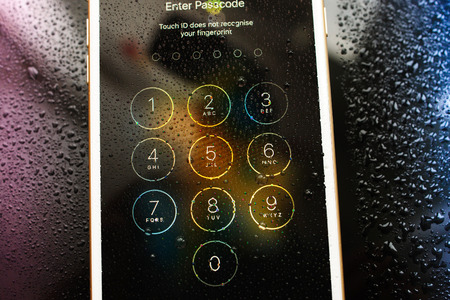 PARIS, FRANCE - SEP 26, 2016: New Apple iPhone 7 Plus unboxing and testing - enter passcode afer touch id did not recognised fingeprint. New iPhone7 is one of the best waterproof smart phone in the worldのeditorial素材