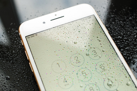 PARIS, FRANCE - SEP 26, 2016: New Apple iPhone 7 Plus unboxing and testing - no sim sign covered with water drops and passcode. New iPhone7 is one of the best waterproof smart phone in the worldのeditorial素材
