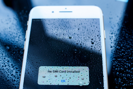 PARIS, FRANCE - SEP 26, 2016: New Apple iPhone 7 Plus unboxing and testing -  no sim card installed under rain drops on screen.  New iPhone7 is one of the best waterproof smart phone in the worldのeditorial素材
