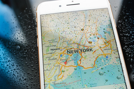 PARIS, FRANCE - SEP 26, 2016: New Apple iPhone 7 Plus unboxing and testing - New York map on smartphone under rain. New iPhone7 is one of the best waterproof smart phone in the worldのeditorial素材