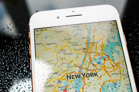 PARIS, FRANCE - SEP 26, 2016: New Apple iPhone 7 Plus unboxing and testing - New York map on smartphone under rain. New iPhone7 is one of the best waterproof smart phone in the worldのeditorial素材