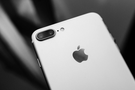PARIS, FRANCE - SEP 26, 2016: New Apple iPhone 7 Plus unboxing and testing - black and white phone on glass background . New iPhone7 is one of the best waterproof smart phone in the worldのeditorial素材