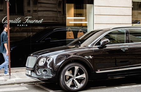 PARIS, FRANCE - MAY 21, 2016: Man admiring the luxury Bentley Bentayga Hybrid SUV on the streets of Paris, Franceのeditorial素材