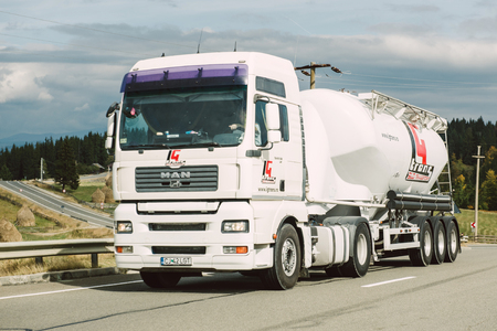 BRASOV, ROMANIA - NOV 10,2014: Man truck with cistern on highway near the Romanian city of Brasovのeditorial素材