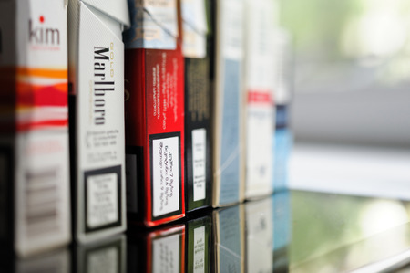 FRANKFURT, GERMANY - SEP 22, 2012: Row of packs of cigarettes from diverse corners of the world with all indications of nicotine massのeditorial素材