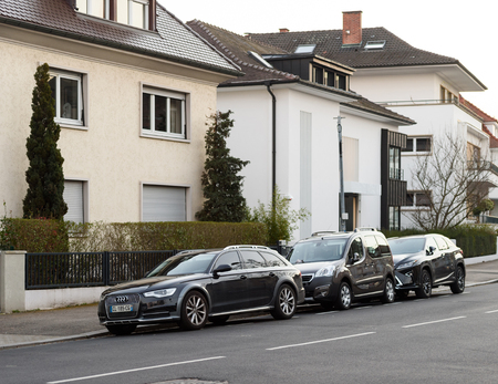 STRASBOURG, FRANCE - MAR 18, 2016: AUDI wagon, Peugeot Car and Lexus Luxury SUV parked in front of luxury houses on calm city street neighborhoodのeditorial素材