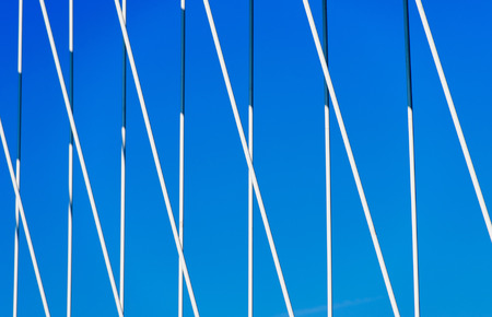 Bridge detail against clear summer sky - powerful iron holding bridgeの写真素材