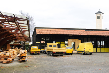 Factory company fleet of generic commercial lorries and van parked in a row ready for cargo distribution of wooden manufactured productsの写真素材