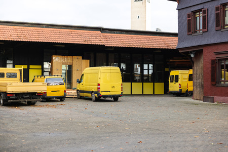 Yellow van, yellow truck and pick-up in industrial environment near factory and distribution warehouseのeditorial素材