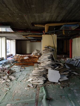 Vertical view of abandoned interior of a business store market with lots of damaged lamps, wallsの写真素材