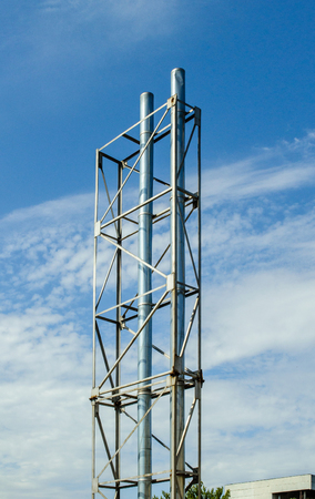 Beautiful steel pipes of a factory against clear blue skyの写真素材