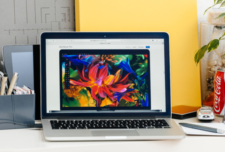 PARIS, FRANCE - OCT 28 2016: Apple Computers website on new MacBook Pro Retina with OLED touch bar in a geek creative room showcasing new professional laptop - front view of the new screen with wide gamutのeditorial素材
