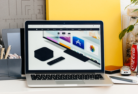 PARIS, FRANCE - OCT 28 2016: Apple Computers website on new MacBook Pro Retina with OLED touch bar in a geek creative room showcasing the new TV app from appleのeditorial素材