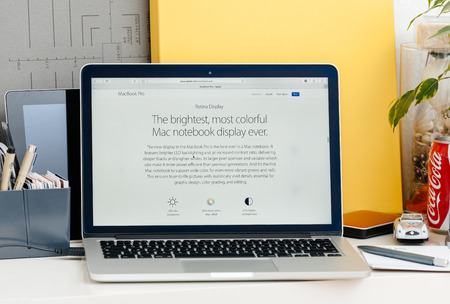 PARIS, FRANCE - OCT 28 2016: Apple Computers website on new MacBook Pro Retina with OLED touch bar in a geek creative room showcasing new professional laptop - new display screen specification, wider gamut, brighter displayのeditorial素材