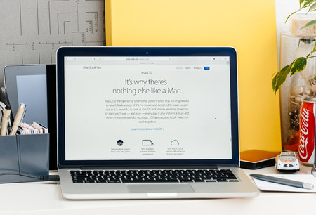 PARIS, FRANCE - OCT 28 2016: Apple Computers website on new MacBook Pro Retina with OLED touch bar in a geek creative room showcasing new professional laptop - detail of new macOS operating systemのeditorial素材