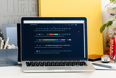 PARIS, FRANCE - OCT 28 2016: Apple Computers website on new MacBook Pro Retina with OLED touch bar in a geek creative room showcasing new professional laptop - detail of the new touch bar and its shorcuts elements on screen for diverse applicationsのeditorial素材