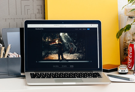 PARIS, FRANCE - OCT 28 2016: Apple Computers website on new MacBook Pro Retina with OLED touch bar in a geek creative room showcasing new professional laptop - detail of game runnning on the new laptopのeditorial素材