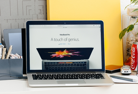 PARIS, FRANCE - OCT 28 2016: Apple Computers website on new MacBook Pro Retina with OLED touch bar in a geek creative room showcasing new professional laptop - detail of Touch Bar with A touch of Genius advertising message of the new OLED screenのeditorial素材