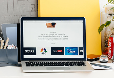PARIS, FRANCE - OCT 28 2016: Apple Computers website on new MacBook Pro Retina with OLED touch bar in a geek creative room showcasing new professional laptop - detail of single sign-on for every TV appのeditorial素材