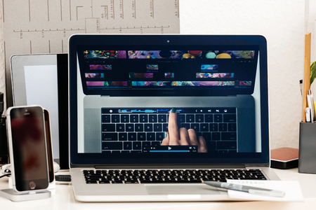 PARIS, FRANCE - OCT 28 2016: Hand touch OLED bar - Apple Computers website on new MacBook Pro Retina with OLED Touch bar in geek creative room showcasingのeditorial素材