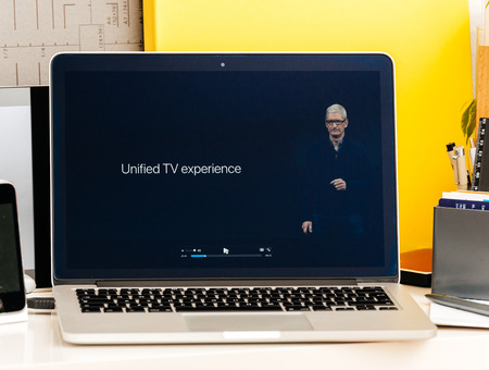 PARIS, FRANCE - OCT 28 2016: Apple Computers website on new MacBook Pro Retina with OLED Touch bar in geek creative room showcasing Apple Keynote - Tim Cook about Unified TV experienceのeditorial素材
