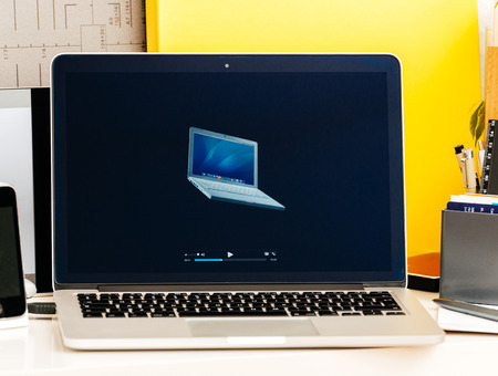 PARIS, FRANCE - OCT 28 2016: Apple Computers website on new MacBook Pro Retina with OLED Touch bar in geek creative room showcasing Apple Keynote presentation all MacBook pro, PowerBook and iBook laptops historyのeditorial素材