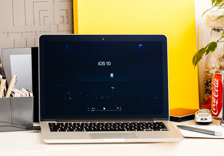 PARIS, FRANCE - OCT 28 2016: Apple Computers website on new MacBook Pro Retina with OLED Touch bar in geek creative room showcasing Apple Keynote presentation of iOS 10 by tim Cookのeditorial素材
